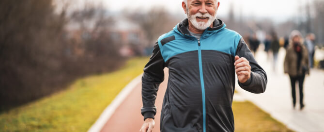 A happy and active senior man on a run outdoors