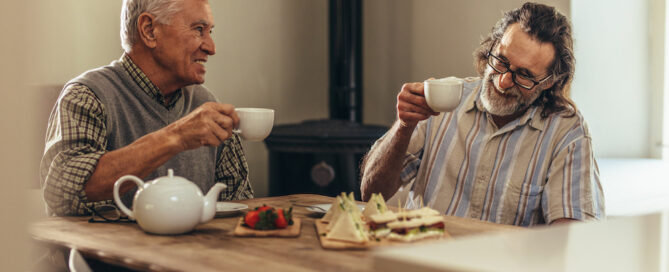 Two senior men enjoy afternoon tea together at the Jacksonville senior apartments