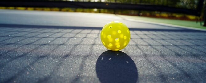 Close up of a pickleball on a pickleball court