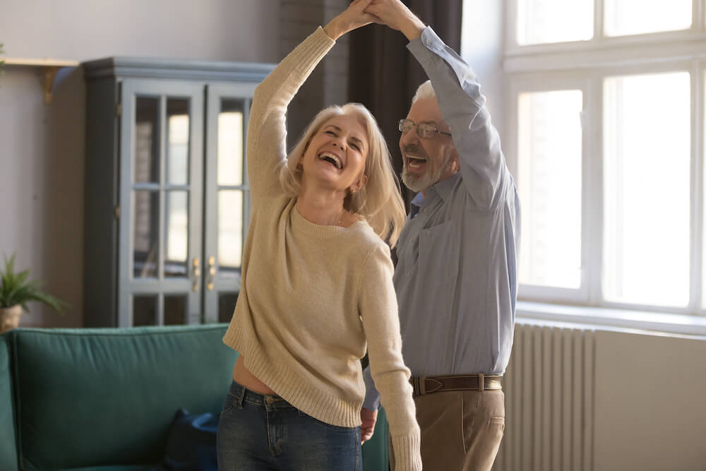 A senior couple laughing and dancing at the senior housing independent living in Jacksonville