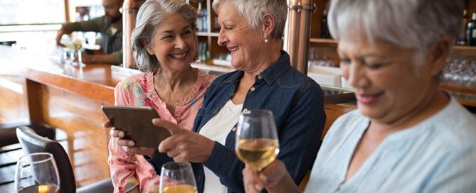 Senior female friends using tablet