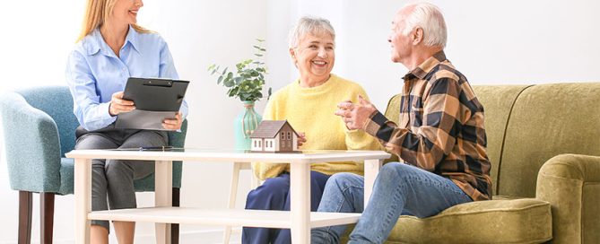 Female real estate agent working with senior couple
