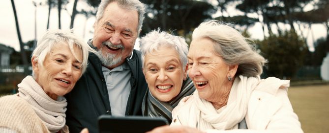 Senior people, happy or friends take a selfie in park together for a memory with smile or joy outdoors. Group, old man or elderly women taking photo or picture in nature for social media for vlogging